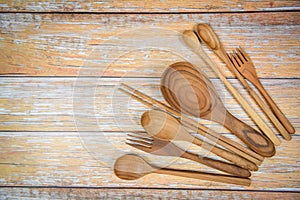 Natural kitchen tools wood products / Kitchen utensils background with spoon fork chopsticks ladle and dessert spoon various sizes