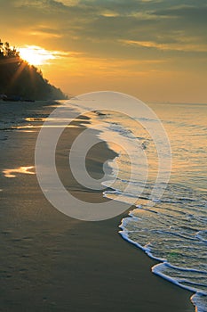 Natural land scape of sun rising on sea beach vertical form