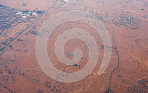 Natural landscape aerial view of the desert with roads and build