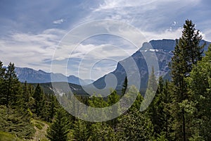 Natural landscape - Bow River Valley, Rocky Mountains, coniferous forest and beautiful sky with clouds.