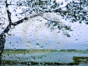 Natural Landscape Outside The Window With Rain Drops On The Glass