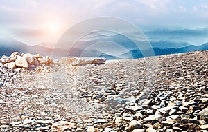 Natural landscape skyline with stone ground and rolling mountains.