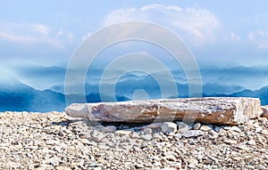 Natural landscape skyline with stone ground and rolling mountains.