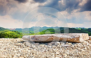 Natural landscape skyline with stone ground and rolling mountains.