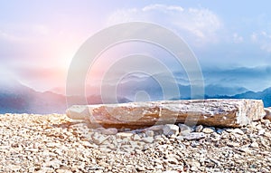 Natural landscape skyline with stone ground and rolling mountains.