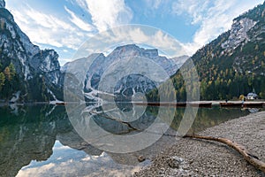 Natural landscapes of the lake Braies Lago di Braies with morning fog and reflection of the mountain peak in Dolomites, Italy photo