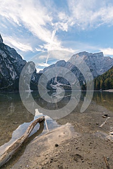 Natural landscapes of the lake Braies Lago di Braies with morning fog and reflection of the mountain peak in Dolomites, Italy photo