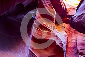 Natural landscapes of vibrant sandstones stacked in flaky fire waves in a narrow sandy labyrinth in Lower Antelope Canyon in Page