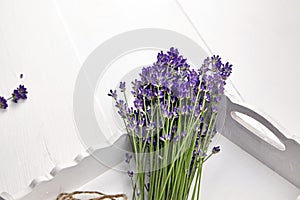 Natural lavender flowers bunch in white wooden tray