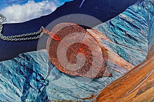 Natural leaf electroplated in orange color .