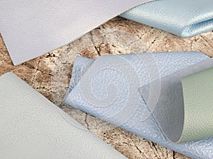 Natural leather textures samples on brown stone background