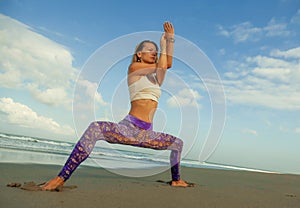 Natural lifestyle portrait of young happy and attractive fit and slim blond woman doing yoga and relaxation exercise outdoors at