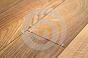 Natural light brown wooden parquet floor boards. Sunny soft yellow texture, copy space perspective background