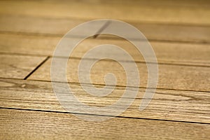 Natural light brown wooden parquet floor boards. Sunny soft yellow texture, copy space perspective background