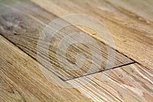 Natural light brown wooden parquet floor boards. Sunny soft yellow texture, copy space perspective background