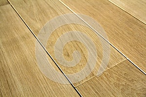 Natural light brown wooden parquet floor boards. Sunny soft yellow texture, copy space perspective background