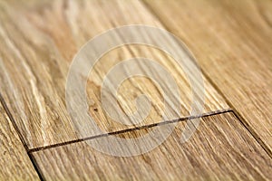 Natural light brown wooden parquet floor boards. Sunny soft yellow texture, copy space perspective background