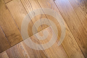 Natural light brown wooden parquet floor boards. Sunny soft yellow texture, copy space perspective background