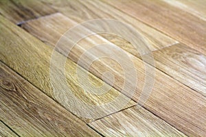 Natural light brown wooden parquet floor boards. Sunny soft yellow texture, copy space perspective background