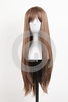 Natural looking brunet wig on white mannequin head