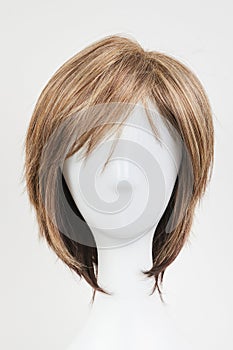 Natural looking brunet wig on white mannequin head
