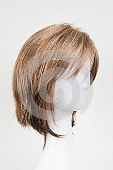 Natural looking brunet wig on white mannequin head