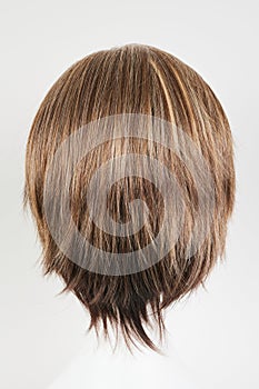 Natural looking brunet wig on white mannequin head