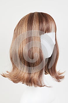 Natural looking dark brunet wig on white mannequin head