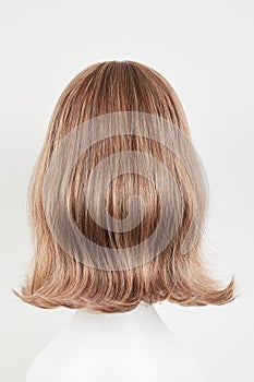 Natural looking dark brunet wig on white mannequin head