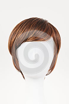 Natural looking dark brunet wig on white mannequin head