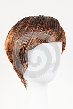 Natural looking dark brunet wig on white mannequin head