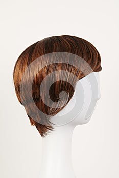 Natural looking dark brunet wig on white mannequin head