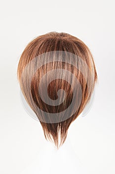 Natural looking dark brunet wig on white mannequin head