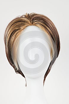 Natural looking dark brunet wig on white mannequin head