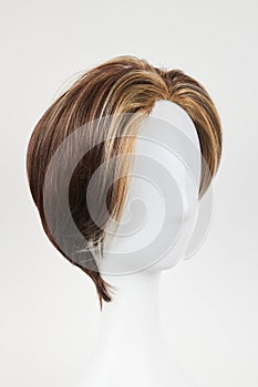 Natural looking dark brunet wig on white mannequin head