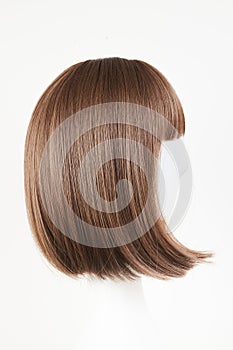 Natural looking dark brunet wig on white mannequin head