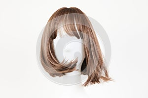 Natural looking dark brunet wig on white mannequin head