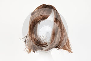 Natural looking dark brunet wig on white mannequin head