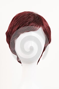Natural looking red brunet wig on white mannequin head