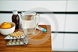 Natural and medical cold and flu remedies on table at home. Cold and flu influenza fall autumn and winter season. Cup