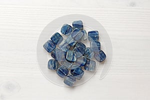 Natural mineral blue kyanite on a white wooden background