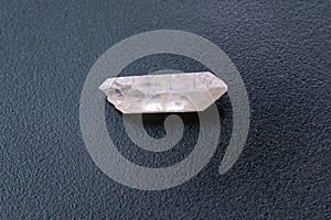 Natural mineral from geological collection raw clear quartz rock crystal stone, black background