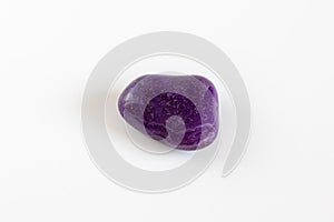 Natural mineral stone, purple gemstone isolated on white