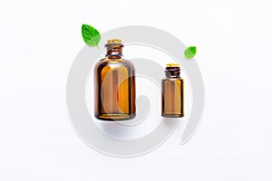 Natural Mint Essential Oil in a Glass Bottle with Fresh Mint Lea