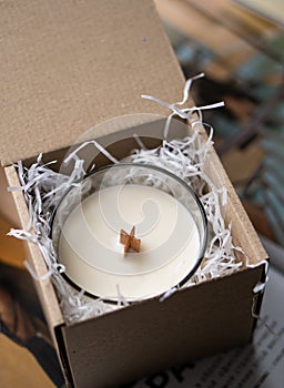 Natural new soy wax candle with wooden wick in clear glass jar