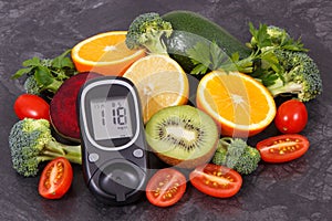 Natural nutritious fruits with vegetables and glucometer with result of sugar level, diabetes and healthy lifestyles concept