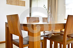 Natural oak wood dining table and chairs in neutral modern inter