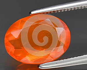 natural orange fire opal gem on the background