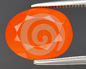 natural orange fire opal gem on the background