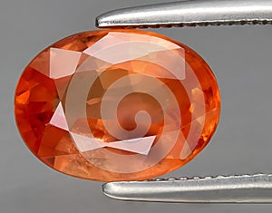 natural orange padparadscha sapphire gem on the background photo